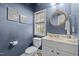 Cozy powder room features wainscoting, a custom mirror, and a bright window, creating a charming space at 1404 Vanguard Pl, Durham, NC 27713