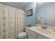 Clean bathroom featuring a framed mirror, a single vanity and a shower with curtain at 1404 Vanguard Pl, Durham, NC 27713