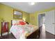 Bright bedroom with a floral bedspread, and hardwood floors, and abundant natural light at 1404 Vanguard Pl, Durham, NC 27713