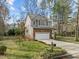 Two-story home with a well-maintained lawn, fenced yard, and attached garage at 1404 Vanguard Pl, Durham, NC 27713