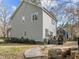 Two-story home with light gray siding, well-maintained lawn, mature trees, and a beautiful backyard space at 1404 Vanguard Pl, Durham, NC 27713