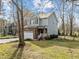 Exterior view of the home with an attached garage, stone accents, and a well-kept lawn at 1404 Vanguard Pl, Durham, NC 27713