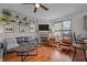 Comfortable living room featuring a fireplace, hardwood floors, a ceiling fan, and natural light at 1404 Vanguard Pl, Durham, NC 27713