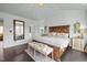 Large primary bedroom with a decorative accent mirror and en suite bathroom access offers comfort and convenience at 1404 Vanguard Pl, Durham, NC 27713