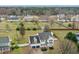 An aerial view of a charming two-story home in a peaceful neighborhood, surrounded by trees at 1421 Harvey Johnson Rd, Raleigh, NC 27603