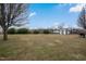 Expansive backyard featuring a shed, bordered by a wooden fence and lush greenery, perfect for outdoor activities at 1421 Harvey Johnson Rd, Raleigh, NC 27603
