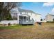 A backyard featuring a wooden deck, seating, grilling area, and a view of the home at 1421 Harvey Johnson Rd, Raleigh, NC 27603