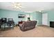Spacious game room with ceiling fans, TV, large couch and entertainment space at 1421 Harvey Johnson Rd, Raleigh, NC 27603