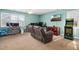 Game room with large comfortable couch, ceiling fan, TV and an arcade game at 1421 Harvey Johnson Rd, Raleigh, NC 27603