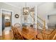 Inviting dining room next to staircase features a wooden table, seating for six, and elegant lighting fixture at 1421 Harvey Johnson Rd, Raleigh, NC 27603