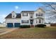 Charming two-story home with blue shutters, a two-car garage, and a beautifully landscaped front yard at 1421 Harvey Johnson Rd, Raleigh, NC 27603