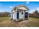 Playhouse featuring a covered porch, blue door, and swing at 1421 Harvey Johnson Rd, Raleigh, NC 27603
