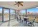 Covered porch with outdoor seating, ceiling fan, and scenic views at 1421 Harvey Johnson Rd, Raleigh, NC 27603