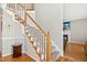 Elegant staircase with wooden handrail and white spindles, leading to the upper level of the home at 1421 Harvey Johnson Rd, Raleigh, NC 27603