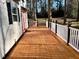 Back porch with wood floors and white railings offers a relaxing outdoor space at 1517 Peace St, Henderson, NC 27536