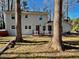 Back exterior view of a two story home with a deck and a hot tub at 1517 Peace St, Henderson, NC 27536
