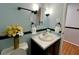 Small bathroom with a vessel sink and floral arrangement at 1517 Peace St, Henderson, NC 27536
