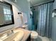 Bathroom with a modern sink, ample lighting, and a shower with a patterned curtain at 1517 Peace St, Henderson, NC 27536