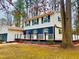 Two-story home with a wrap-around porch and a detached garage surrounded by a well-maintained yard and mature trees at 1517 Peace St, Henderson, NC 27536