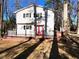 Exterior view of a two-story home with a deck, red doors, and black shutters at 1517 Peace St, Henderson, NC 27536