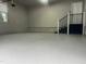 Clean, spacious garage featuring epoxy flooring and brick detail for a modern, functional workspace at 1517 Peace St, Henderson, NC 27536