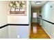 Hallway with hardwood floors and light blue walls at 1517 Peace St, Henderson, NC 27536