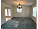 Large living room with grey carpet and a modern light fixture at 1517 Peace St, Henderson, NC 27536