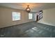 Spacious living room with a carpet and stairs with black railing and a red door at 1517 Peace St, Henderson, NC 27536