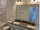 Bathroom with dual sink vanity, large mirror, and shower-tub combination at 1573 Wendell Valley Blvd, Wendell, NC 27591