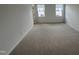 Spacious bedroom with neutral carpet, natural light from two windows, and ample space at 1573 Wendell Valley Blvd, Wendell, NC 27591