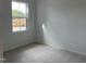 A carpeted bedroom with a window showcasing construction vehicles outside at 1573 Wendell Valley Blvd, Wendell, NC 27591