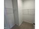 Walk-in closet with wire shelving and neutral carpet, offering ample storage space at 1573 Wendell Valley Blvd, Wendell, NC 27591