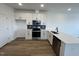 Clean kitchen featuring white cabinets, quartz countertop, stainless steel appliances, and sleek black hardware at 1573 Wendell Valley Blvd, Wendell, NC 27591