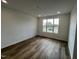 Spacious living room featuring wood-look flooring and large window offering lots of natural light at 1573 Wendell Valley Blvd, Wendell, NC 27591