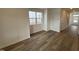 Bright, open-concept living room with wood-look flooring and large window to bring in natural light at 1573 Wendell Valley Blvd, Wendell, NC 27591