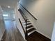 Elegant staircase featuring dark wood treads, white risers, and a hardwood floor at 1573 Wendell Valley Blvd, Wendell, NC 27591