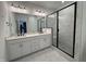 Modern bathroom showcasing a double vanity and walk-in shower with black trim and marble accents at 1581 Wendell Valley Blvd, Wendell, NC 27591