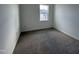 Neutral carpeted bedroom featuring a window letting in natural light at 1581 Wendell Valley Blvd, Wendell, NC 27591