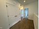 Hallway with wood flooring offering closet space and views into adjacent rooms at 1581 Wendell Valley Blvd, Wendell, NC 27591