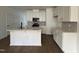 Well-lit kitchen featuring modern cabinets, an island with bar seating, and stainless steel appliances at 1581 Wendell Valley Blvd, Wendell, NC 27591