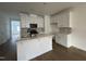 Open kitchen features white cabinets, granite countertops, and an island with stainless steel sink at 1581 Wendell Valley Blvd, Wendell, NC 27591