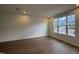 Bright living room showcasing wood flooring and a large window with scenic neighborhood views at 1581 Wendell Valley Blvd, Wendell, NC 27591