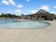 A modern community pool with lounge chairs and a wading area with fountains, perfect for relaxation at 1581 Wendell Valley Blvd, Wendell, NC 27591