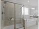 Elegant bathroom featuring a glass-enclosed shower and separate soaking tub at 163 English Violet Lane Ln, Raleigh, NC 27610