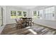 Bright dining room boasts hardwood floors, a wooden table, and oversized windows overlooking the lawn at 163 English Violet Lane Ln, Raleigh, NC 27610