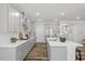 Bright kitchen with white quartz countertops, stainless steel appliances, and a large island at 163 English Violet Lane Ln, Raleigh, NC 27610