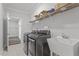 Spacious laundry room featuring a utility sink, modern washer, and dryer, and shelving at 163 English Violet Lane Ln, Raleigh, NC 27610