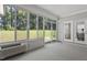 Bright sun room with expansive windows offering views of the lush backyard at 163 English Violet Lane Ln, Raleigh, NC 27610