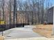 Asphalt trail leading into wooded area with caution sign; neighborhood trail access at 163 English Violet Lane Ln, Raleigh, NC 27610