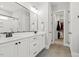 Modern bathroom featuring double vanity sinks, sleek fixtures, and a walk-in shower, plus closet at 1737 Fence Post Rd, Wendell, NC 27591